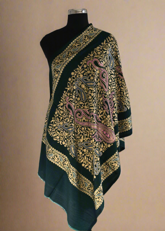 Dark green shawl with gold and pink paisley patterns on a mannequin against a white background