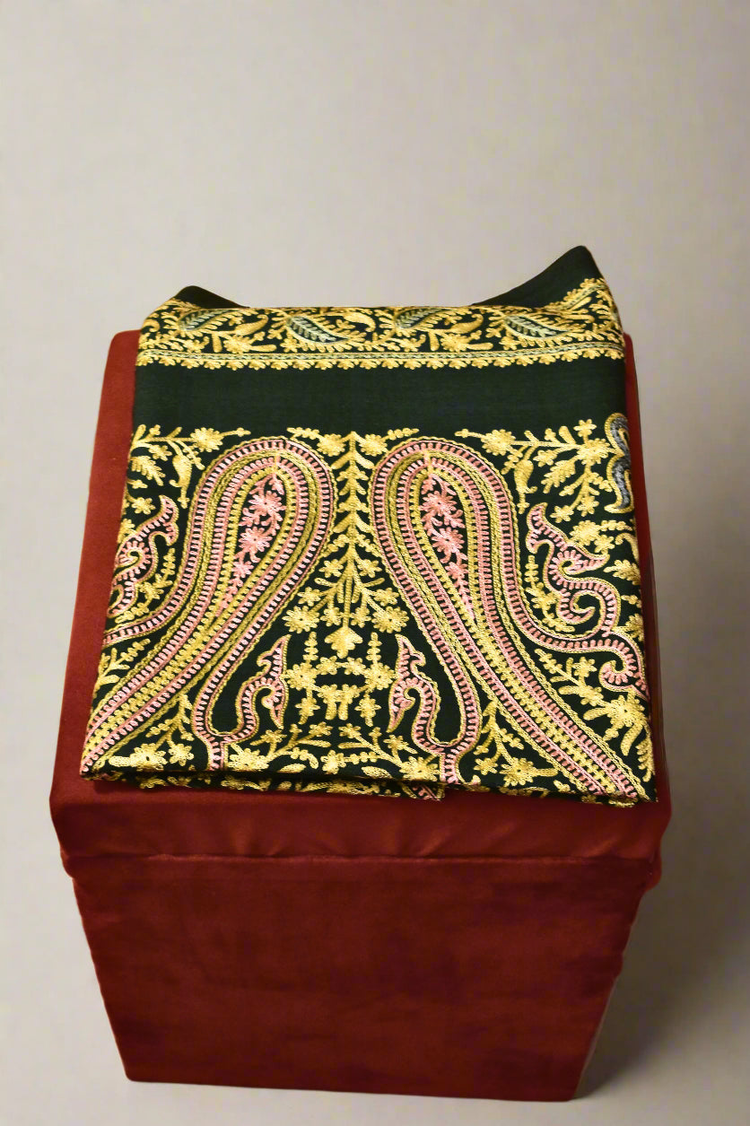 Decorative stole with a patterned cover on a wooden floor.