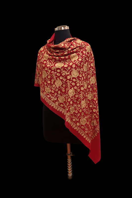 Red shawl with gold embroidery on a black background